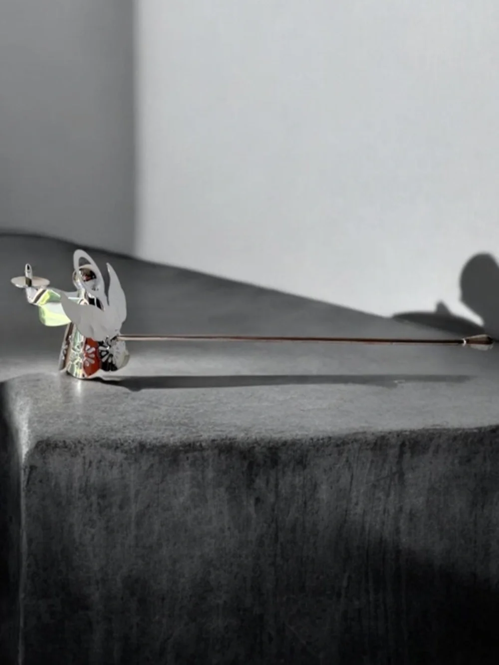 silver-tone angel candle snuffer features intricate, cutout wing and robe